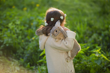 beautiful girl with a rabbit in the woods
