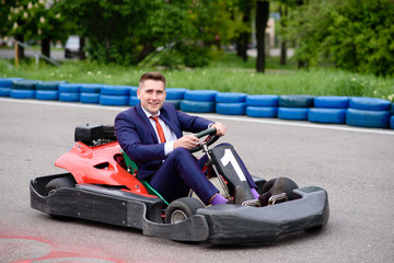 Businessman driving a child vehicle.