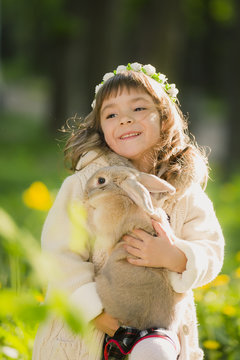 beautiful girl with a rabbit in the woods