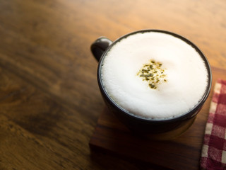 Hot Green tea latte on wood table