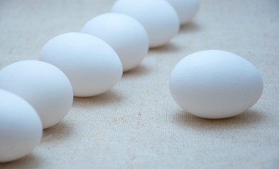 A row of white chicken eggs.
