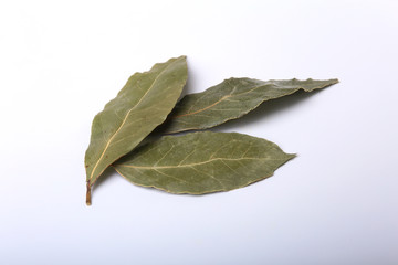 Aromatic dried bay leaves on white background.