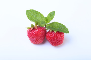 Fresh strawberries and mint leaves isolated on white background. Selective focus.