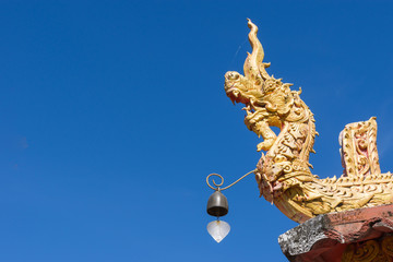 Fototapeta premium Golden dragon statue with blue sky background