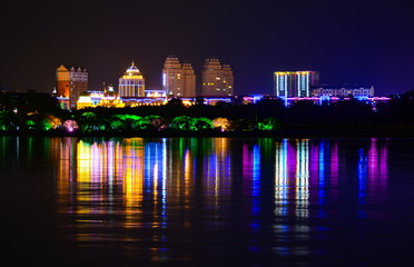 Bright lights of the night city, reflection in the water