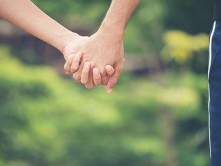 Image of couple holding hands together.