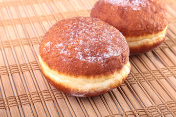 Homemade Doughnuts with Jelly filled and powdered sugar on Bamboo tablecloth. Selective focus.