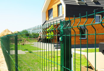 Metal fencing with modern house outdoor. Metal fence design.