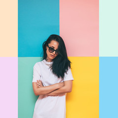 girl in a white dress as a bride and sunglasses on colored background