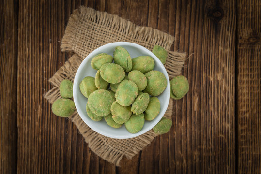 Peanuts (with Wasabi flavor) on vintage wooden background