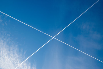 Plane trails in blue sky