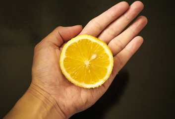 Lemon On Male Hand with Black Background