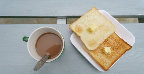 Bread Toast with Cocoa Drink on the gray wooden table.