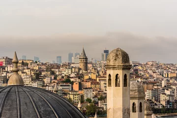 Deurstickers ISTANBUL,TURKEY-MAY 01,2017:View of galata tower  from courtyard of Suleymaniye Mosque through domes of madrasas, Istanbul, Turkey © epic_images