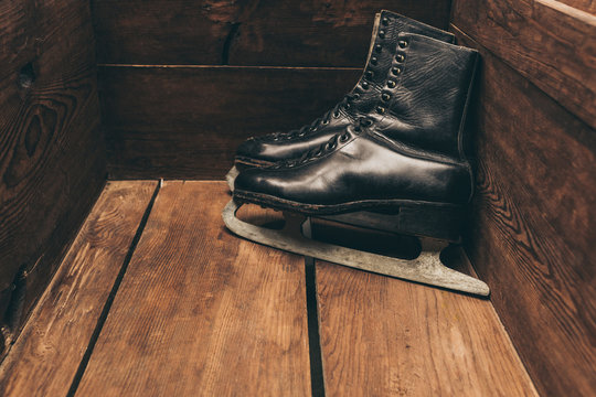 Pair of black vintage sketes standing in wooden box