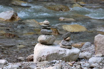 a pyramid of stones near the mountain river
