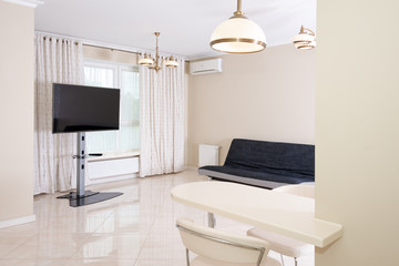 Modern kitchen area attached to the living room. Interior design with classic or vintage and modern elements.