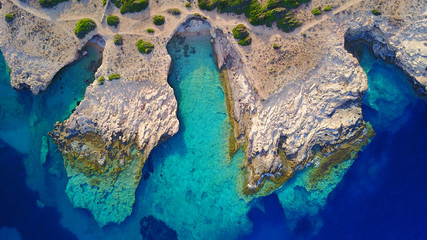 Aerial drone photo of famous caves near Pori beach, Koufonissi island. Cyclades, Greece