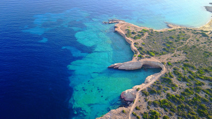 Aerial drone photo of famous caves near Pori beach, Koufonissi island. Cyclades, Greece