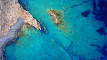 Aerial drone photo of famous caves of Ksylobatis near Pori beach, Koufonissi island. Cyclades, Greece