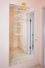 Empty walk-in closet with shelves. Dressing room Interior elements.