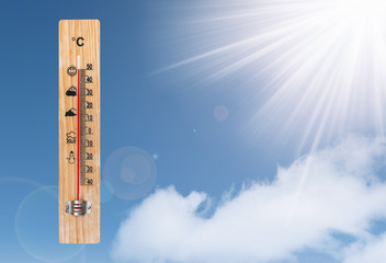 Thermometer and the sun on a blue sky