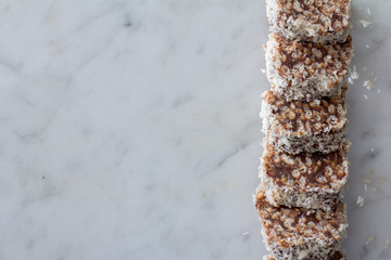 Homemade Date Chocolate Rice Crispy Treats Sliced on Marble Table Top from Above with Copy Space