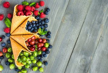Berries in waffle cones grey background