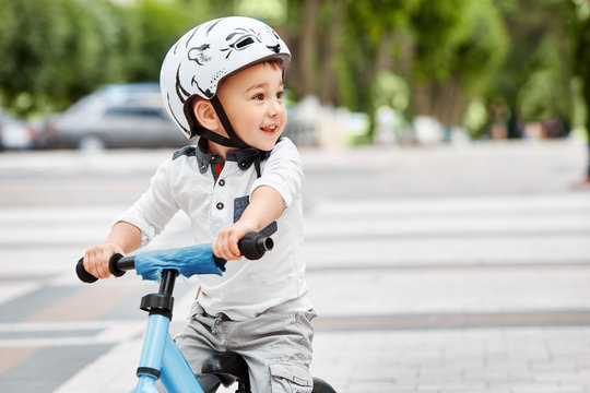 boy in a helmet riding bike