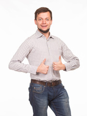 Fototapeta premium Young happy man showing by hands on a gray background. Ideal for banners, registration forms, presentation, landings, presenting concept.