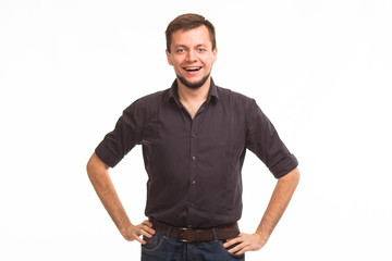 Fototapeta premium Young happy man portrait of a confident businessman showing presentation, pointing paper placard gray background. Ideal for banners, registration forms, presentation, landings, presenting concept.