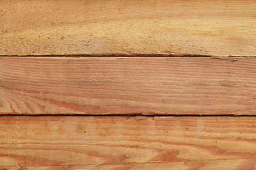 Close-up pattern of stacked wooden plank boards at sawmill lumberyard