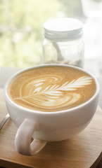 Hot coffee in the cup on table in cafe Morning light , vintage or retro color tone soft focus.