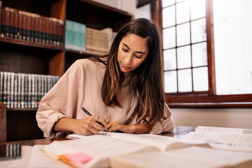 Young caucasian student making notes