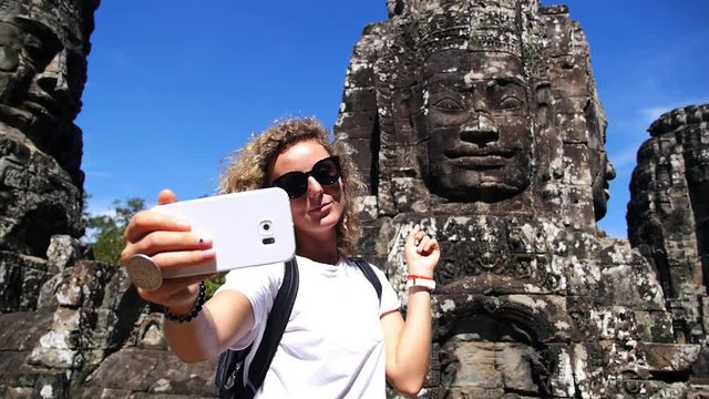 Tourist Woman Making Selfie With Smartphone In Bayon Temple. Angkor Wat. Siem Reap, Cambodia. HD, 1920x1080. 