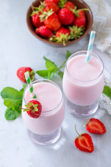 Freshly squeezed strawberry berry cocktail in a glass jar on a gray stone or slate background. Superfoods and health or detox diet nutrition concept.