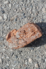 Old broken brick on the asphalt