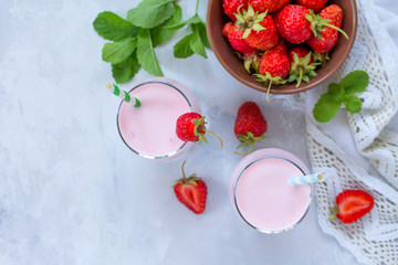 Freshly squeezed strawberry berry cocktail in a glass jar on a gray stone or slate background. Superfoods and health or detox diet nutrition concept. Top view with copy space.