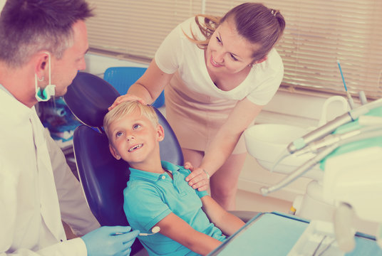 Child with female are visiting dentist