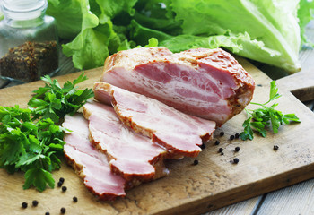 Slices of bacon on the wooden background. Brisket
