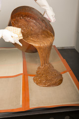 Brown caramel in copper pan ready, dispensing pourring on the pads