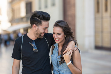 Obraz premium Young happy couple embracing each other laughing