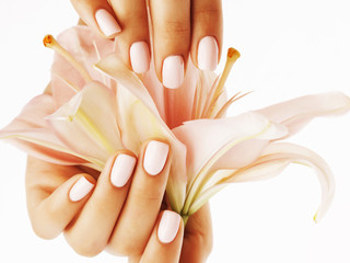 beauty delicate hands with manicure holding flower lily close up isolated on white