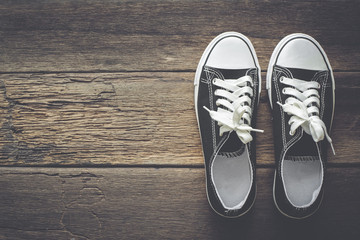 Black shoes on a wooden background with copy space.