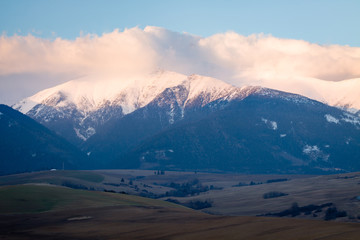 Foothills in Tatra Mountains, Slovakia, with snowy peaks.