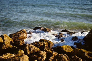 Natural sunny rocky shore outdoors seascape. Coastline abstract background