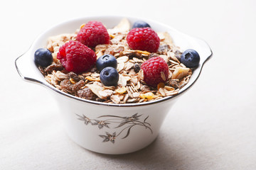 Breakfast cereal with raspberries and blueberries.