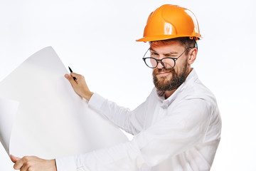 Engineer with a beard on a white isolated background holds a drawing