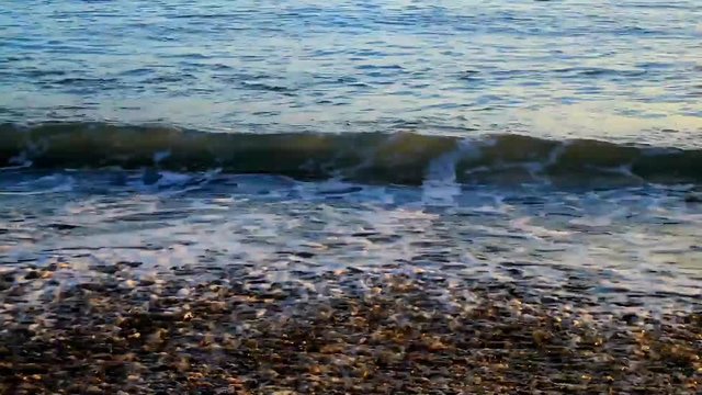 Small waves on beach at sunset