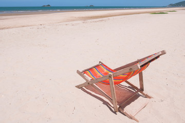 Fototapeta na wymiar Red canvas chair on the beach.